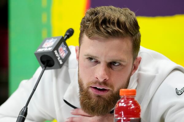 Chiefs placekicker Harrison Butker listening intently during Monday's Super Bowl Opening Night event in New Orleans.