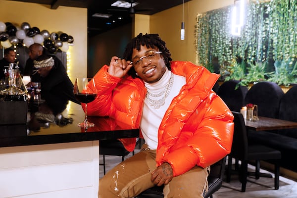 R&B singer Jacquees poses for a photograph at The Wine and Papas Lounge, which he co-owns with Voneka Marks. The restaurant opened its doors a month ago and is located in Stonecrest. Miguel Martinez / miguel.martinezjimenez@ajc.com