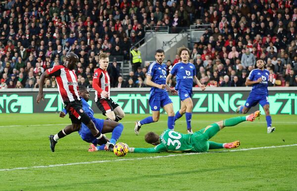 Brentford's Yoane Wissa, left, scores his side's first goal of the game, during the English Premier League soccer match between Brentford and Leicester City at the Gtech Community Stadium, in Brentford, England, Saturday, Nov. 30, 2024. (Steven Paston/PA via AP)