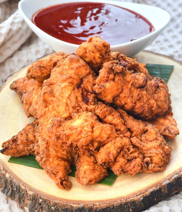 Tandoori Fried Chicken. Farhan Momin made a rudimentary version of spicy fried chicken when he was 6 years old. He's been refining the dish ever since. Traditional Indian tandoori chicken is allowed to soak in yogurt and buttermilk, then cooked in a tandoor — hence the name. Momin's take mingles his combined Indian-Southern heritage: He marinates chicken tenders in a buttermilk-based marinade, then deep-fries it. The sauce shown with it is Maggi Hot & Sweet Chilli Sauce, which Momin calls “Indian ketchup.” (Styling by chef Farhan Momin / Chris Hunt for the AJC)