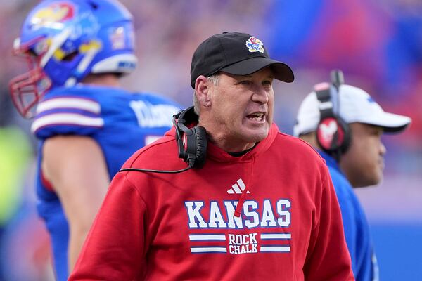 Kansas head coach Lance Leipold talks to his players during the first half of an NCAA college football game against Colorado, Saturday, Nov. 23, 2024, in Kansas City, Mo. (AP Photo/Charlie Riedel)