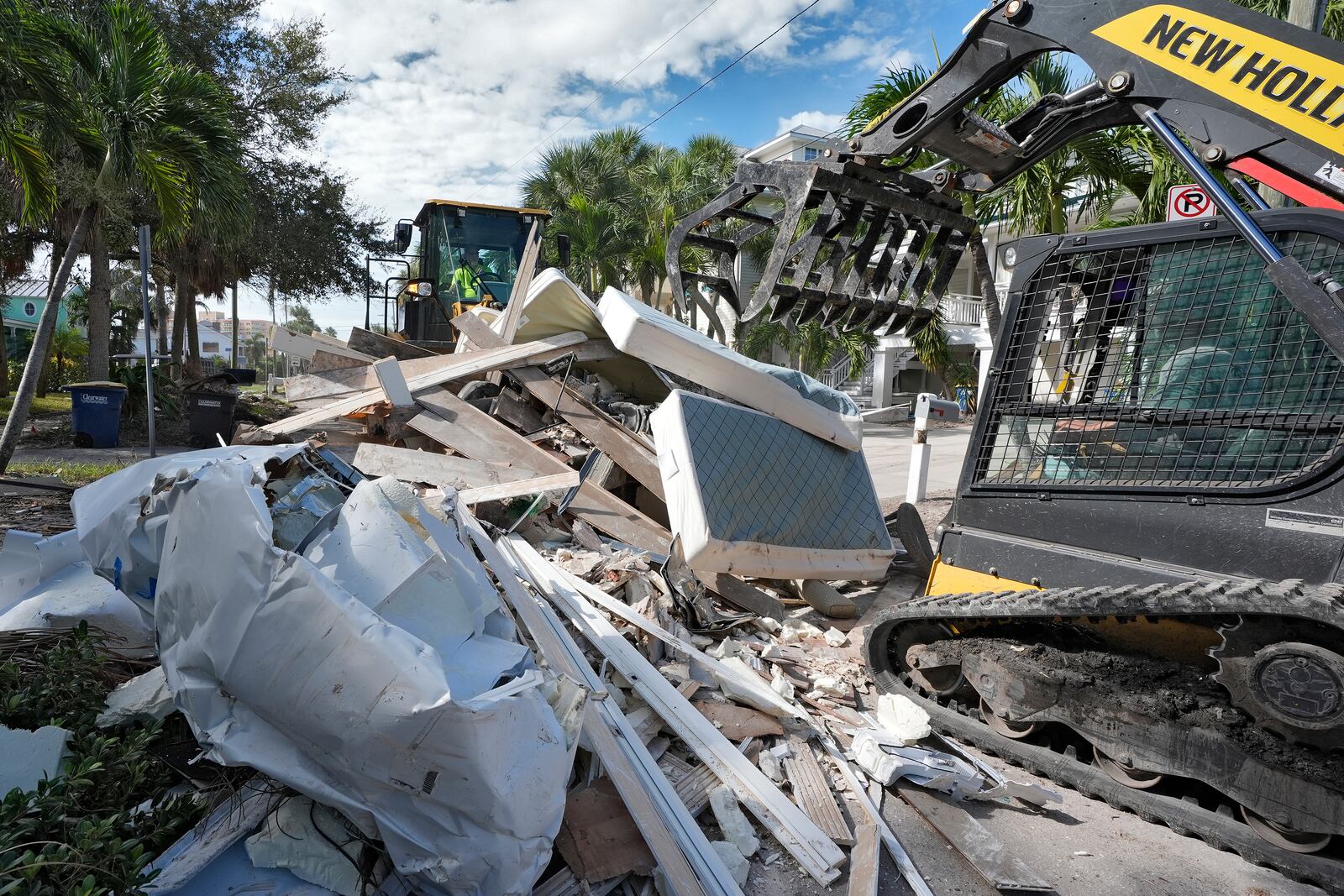 Salvage crews continue to clean up household debris, damaged in Hurricane Helene, Tuesday, Oct. 8, 2024, in Clearwater Beach, Fla., ahead of the possible landfall from Hurricane Milton. (AP Photo/Chris O'Meara)