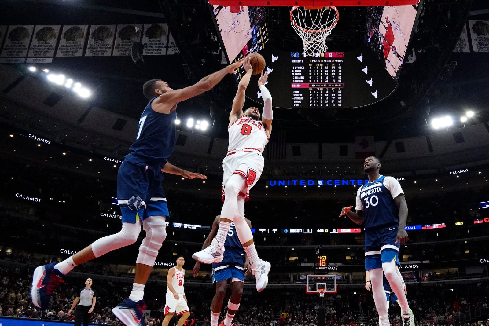 Chicago Bulls guard Zach LaVine (8) shoots against Minnesota Timberwolves center Rudy Gobert, left, as forward Julius Randle looks on during the first half of an NBA preseason basketball game in Chicago, Wednesday, Oct. 16, 2024. (AP Photo/Nam Y. Huh)