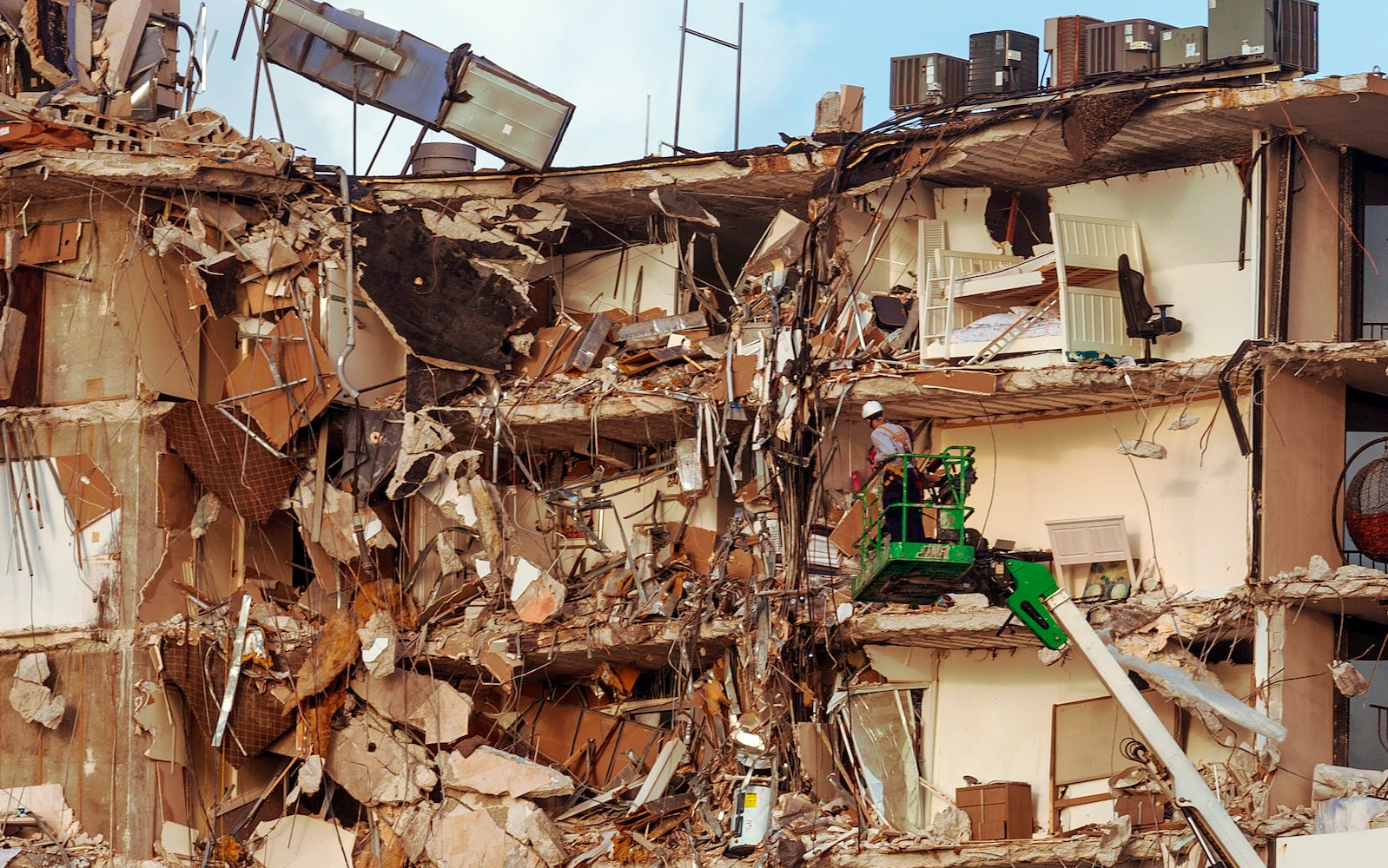 Rescue workers survey the partially collapsed 12-story Champlain Towers South condo building in Surfside, Fla., Friday morning June 25, 2021. (Saul Martinez/The New York Times)