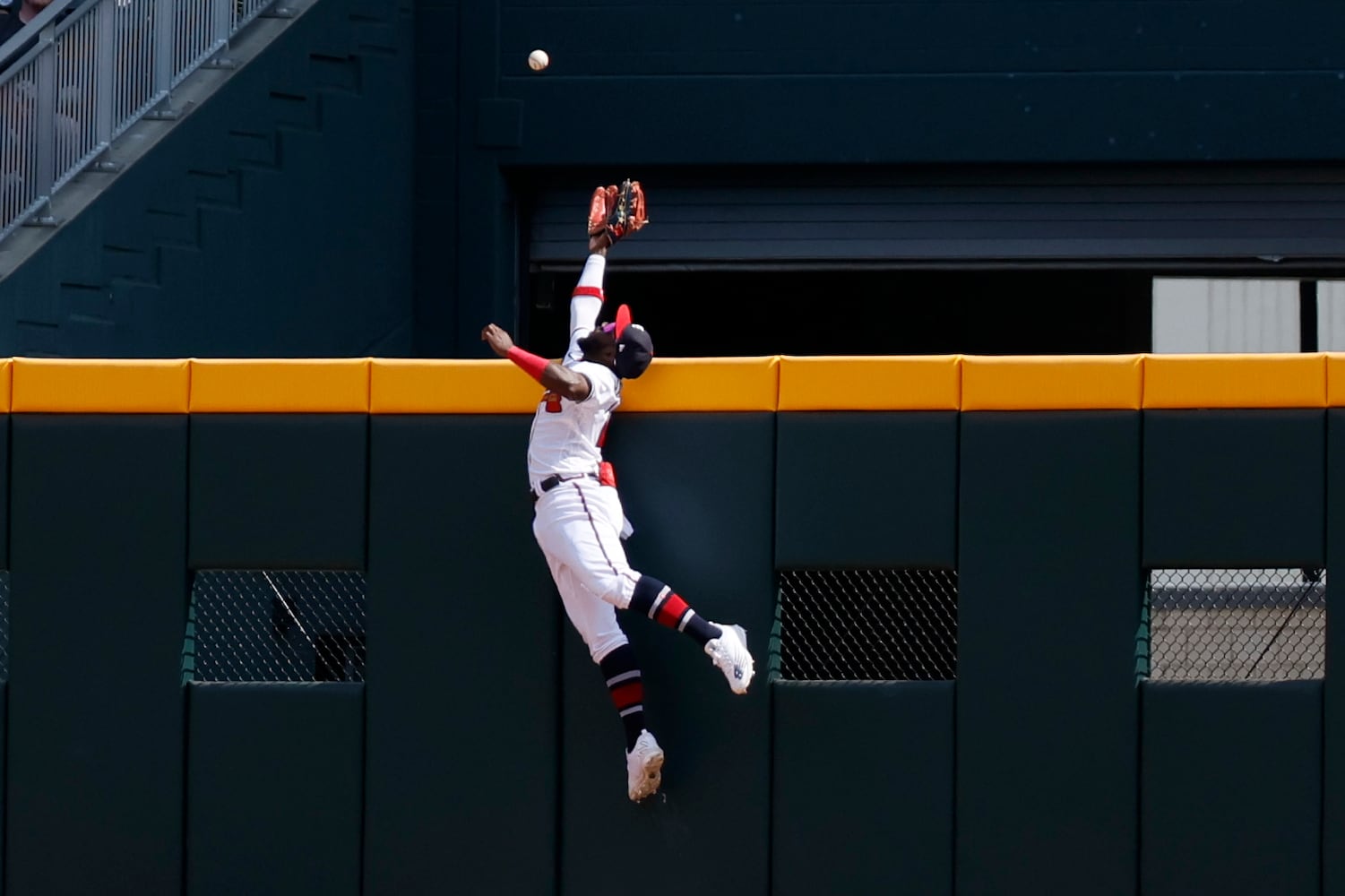 Braves center fielder Michael Harris tries to corral a ball hit by the Phillies' Alec Bohm on Sunday at Truist Park. (Miguel Martinez / miguel.martinezjimenez@ajc.com)