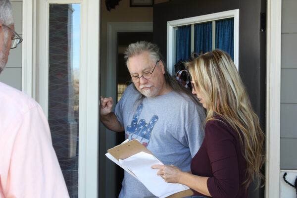 Former Hoschton City Councilman Scott Butler and resident Kelly Winebarger talk to voter Robert Shuler on Nov. 2, 2019, about the campaign to recall Mayor Theresa Kenerly and Mayor Pro Temp Jim Cleveland. The Jackson County Board of Elections voted Tuesday to certify the petitions and set Jan. 14 as the date for a recall election. CHRIS JOYNER / CJOYNER@AJC.COM