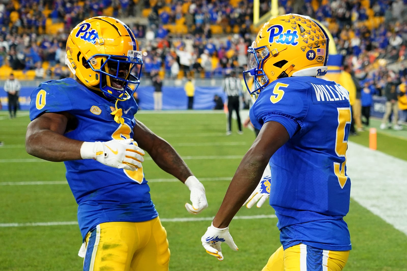 Pittsburgh wide receiver Raphael Williams Jr. (5) celebrates with running back Desmond Reid (0) after scoring a touchdown during the second half of an NCAA college football game against Syracuse, Thursday, Oct. 24, 2024, in Pittsburgh. (AP Photo/Matt Freed)