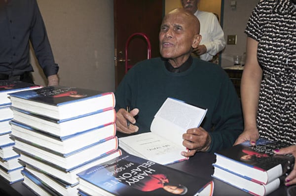 Singer and activist Harry Belafonte works on signing 500 copies of his book "My Song, " before his two-hour conversation at the Jimmy Carter Library on Wednesday, Nov. 16, 2011.