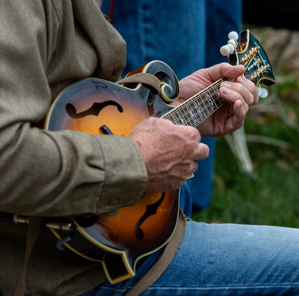 The Druid Hills Billys band member Dave Cooper plays the mandolin as they perform at Clairmont Place in Decatur. The band, made up of physicians in the area, which regularly played at Clairmont Place before the pandemic, kept it up and increased performances during the lockdown. They played outdoors with residents listening from their balconies. PHIL SKINNER FOR THE ATLANTA JOURNAL-CONSTITUTION.