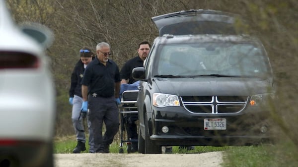 McHenry County Coroner’s Office investigators load the body of 5-year-old Andrew “AJ” Freund Jr. into a minivan near the wooded area in which he was found Wednesday, April 24, 2019, in Woodstock, Ill.