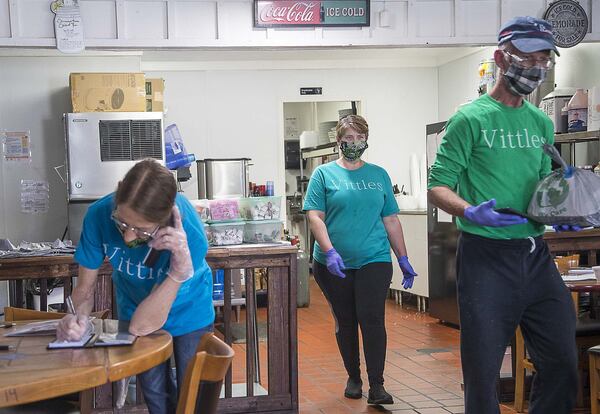 04/21/2020 - Smyrna, Georgia - Charity’s Vittles restaurant owner Charity Salyers (center) works with her crew, server Stacy Wingard (left) and delivery driver Barry Holland (right) at her restaurant in Smyrna, Tuesday, April 21, 2020. Salyer recently sold her car, a 2016 Ford Mustang, in order to keep her business open and her employees paid during the COVID-19 pandemic. (ALYSSA POINTER / ALYSSA.POINTER@AJC.COM)