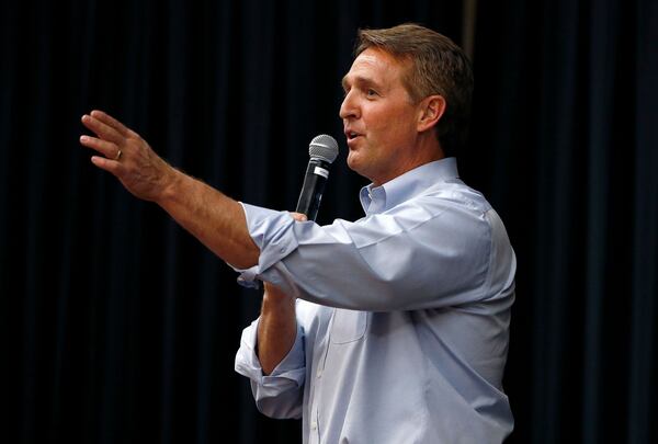 In this April 13, 2017, file photo, Arizona Republican Sen. Jeff Flake takes a question from the audience during a town hall in Mesa, Ariz.