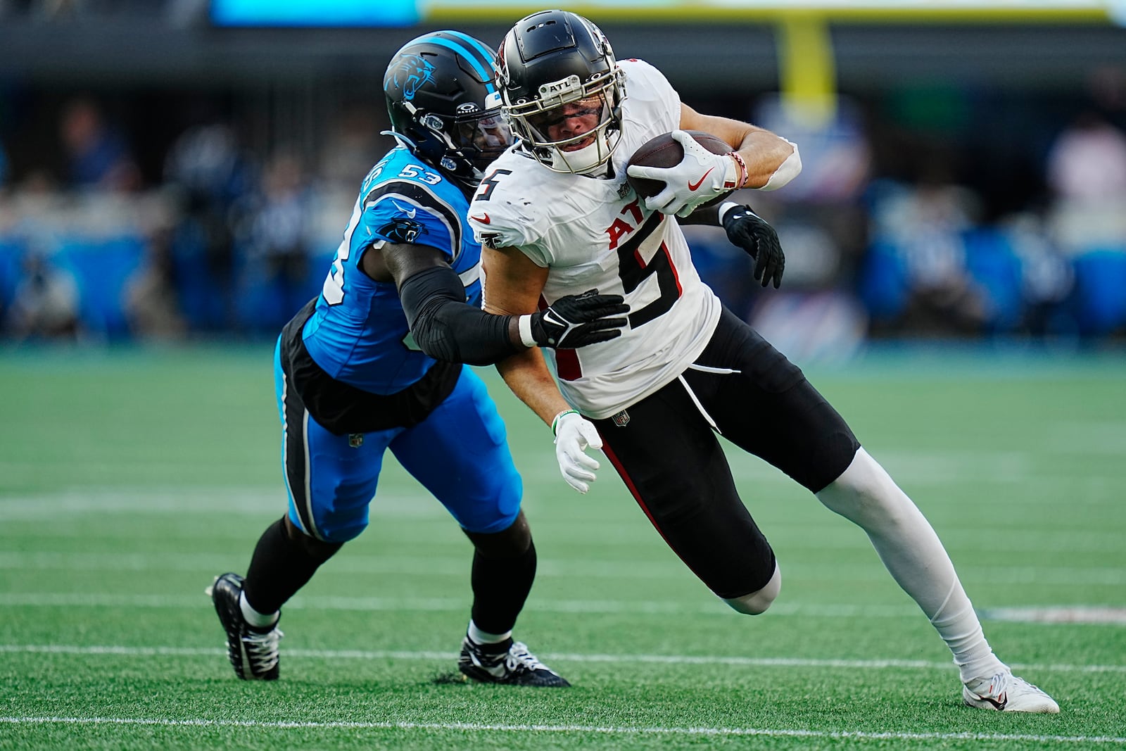 Atlanta Falcons wide receiver Drake London (5) runs the ball against Carolina Panthers linebacker Claudin Cherelus (53) in the first half of an NFL football game in Charlotte, N.C., Sunday, Oct. 13, 2024. (AP Photo/Rusty Jones)