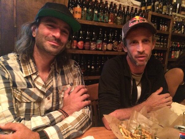 After reaching Springer Mountain Sunday morning at 3:38, Karl Meltzer, right, celebrated with support boss Eric Belz during a meal at The Porter, in Little Five Points. Photo: Bo Emerson