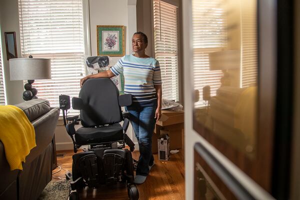 09/18/2020- Roswell, Georgia - Linda McCall, 68, stands near a motorized wheelchair that she fought to obtain for her husband, U.S. Army Veteran Ralph McCall, at her residence in Roswell, Friday, September 18, 2020. ÒIf we could get him back somewhere in Atlanta that would be wonderful,Ó says Linda. Linda says she worked for two years to get her husband a new motorized wheelchair after the one he used at the Decatur Veterans Administration Hospital started showing signs of wear. Due to his recent and sudden move from the Decatur Veterans Administration Hospital to the Dublin Veterans Administration hospital, Ralph has never been able to use the new chair. For now, the new and improved chair sits in her living room.  (Alyssa Pointer / Alyssa.Pointer@ajc.com)