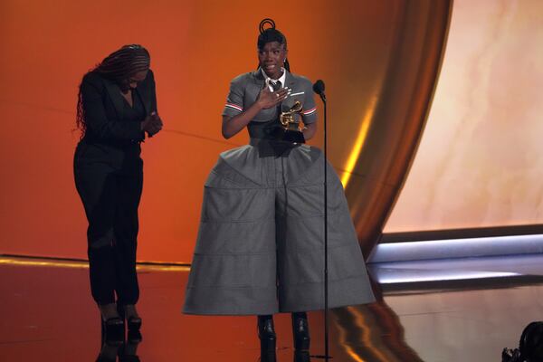 Doechii, center, accepts the award for best rap album for "Alligator Bites Never Heal" during the 67th annual Grammy Awards on Sunday, Feb. 2, 2025, in Los Angeles. Celesia Moore looks on from left(AP Photo/Chris Pizzello)