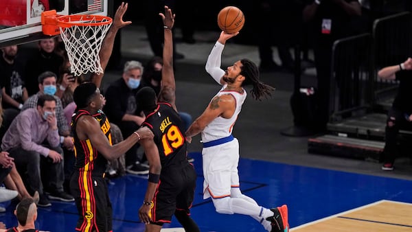 New York Knicks' Derrick Rose (right) drives to the basket through Atlanta Hawks defenders during the second half of Game 1 of first-round playoff series, Sunday, May 23, 2021, in New York. (Seth Wenig/AP)