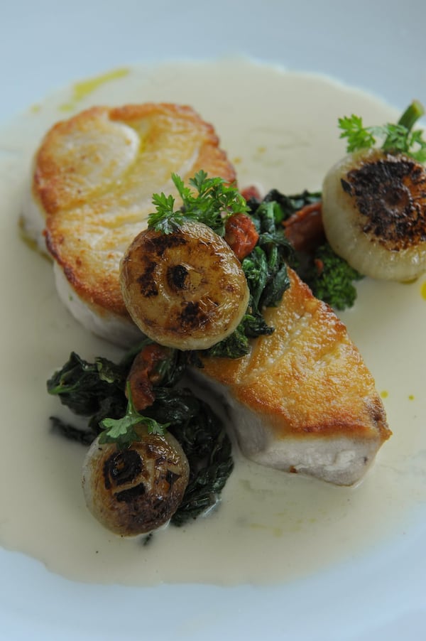 Gulf Black Grouper with roasted cipollini onions, oven dried tomatoes, rapini, corn butter. (BECKY STEIN PHOTOGRAPHY)