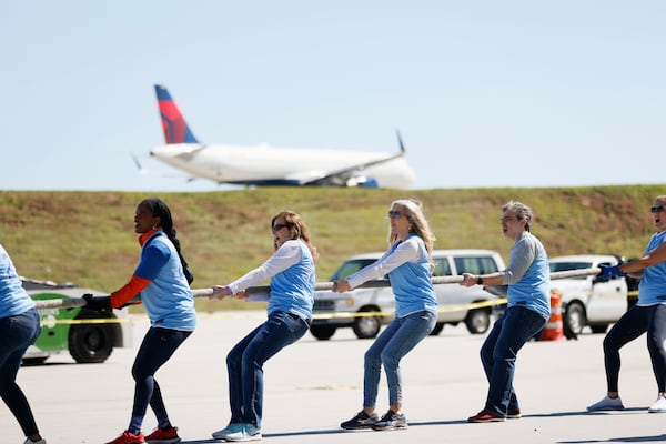 Members of the American Cancer Society pull a 125,000-pound Delta 757-200 aircraft during the fundraising Delta Jet Drag. The event benefits their organization, where over a hundred and fifty teams from Delta employees worldwide pull a 757 aircraft in the quickest amount of time.
Miguel Martinez /miguel.martinezjimenez@ajc.com