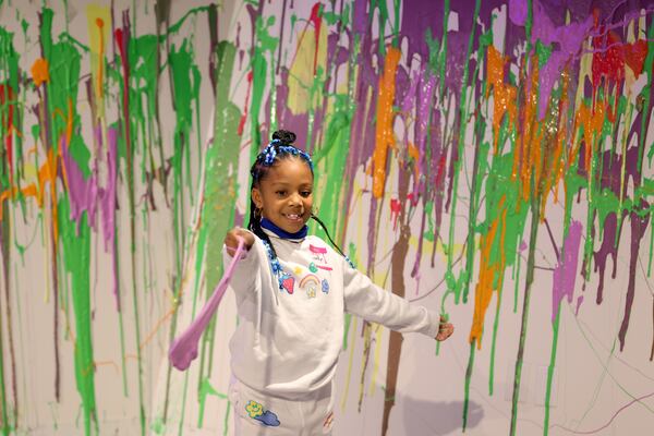 Londyn White, 6, of Atlanta, plays with the slime at Sloomoo in Buckhead, Wednesday, November 16, 2022, in Atlanta. Jason Getz / Jason.Getz@ajc.com)