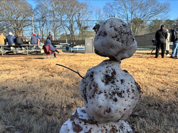 A rapidly melting snowman was among the remnants of the winter storm at Chastain Park on Sunday, Jan. 12, 2025. (David Aaro/AJC)