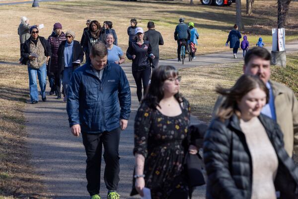 People walk on a path near the Carter Center in Atlanta on Sunday, January 5, 2025. Former president Jimmy Carter, who died at 100, is lying in repose at the center. (Arvin Temkar / AJC)