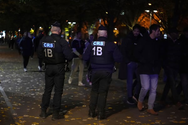 Police officers watch supporters arriving ahead of the Nations League soccer match France against Israel outside the Stade de France stadium, Thursday, Nov. 14, 2024 in Saint-Denis, outside Paris. (AP Photo/Aurelien Morissard)