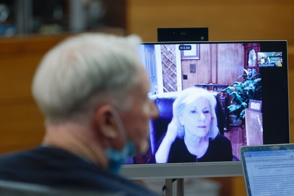 Tex McIver looks on as his sister Dixie Martin makes remarks via Zoom during his bond hearing at Fulton County Courthouse on Friday, October 7, 2022. (Natrice Miller/natrice.miller@ajc.com)  