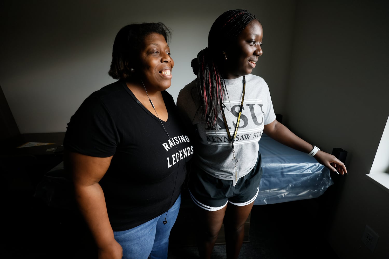 Kimberly Wheelock and her daughter, Tiffany Wheelock, observe the activity in the parking lot from her dorm during the students' arrival at the new building, The Summit at Kennesaw State University, on Wednesday, Aug. 10, 2022. (Miguel Martinez / miguel.martinezjimenez@ajc.com)