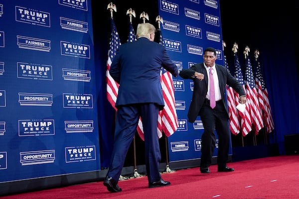 Former President Donald Trump, left, and Republican U.S. Senate candidate Herschel Walker have a close relationship that dates to the 1980s. Walker is more willing to disagree with Trump than most candidates who have the former president's support. “President Trump, I’m very honored that he endorsed me because he knows I’m the right man for the job. But he also knows Herschel Walker is going to do it Herschel Walker’s way,” the candidate told Fox News Radio. (Brendan Smialowski/AFP via Getty Images/TNS)