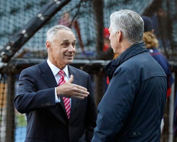 Major League Baseball commissioner Rob Manfred (left) helped lead the sport to a new collective bargaining agreement. (AP file photo/Charles Rex Arbogast)