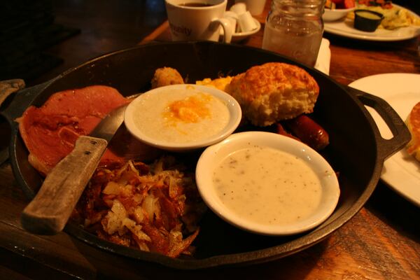 Crockett's Breakfast Camp in Gatlinburg, Tenn., serves the Huntcamp Skillet, a hearty breakfast of cheese grits, sausage, ham, pancakes, hash browns, and more. Almost 300 restaurants are found in Gatlinburg, Pigeon Forge, and Sevierville. (Mary Ann Anderson/TNS)