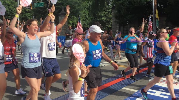 Bill Thorn crosses the finish line of the AJC Peachtree Road Race on Thursday, July 4, 2019.  (Ken Sugiura/AJC)