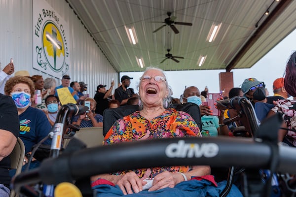 Eleanor Cushing, 91, of Warner Robins sings Wednesday during a campaign rally for Democratic U.S. Sen. Raphael Warnock in Warner Robins. (Arvin Temkar / arvin.temkar@ajc.com)