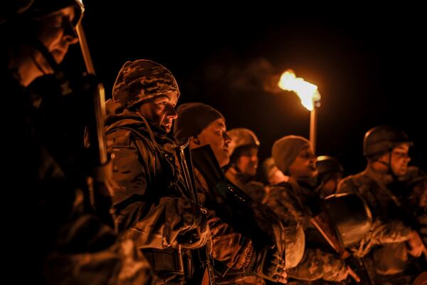 In this photo taken on March 21, 2025 and provided by Ukraine's 24th Mechanized Brigade press service on March 24, 2025, servicemen attend a dedication ceremony for soldiers near the frontline in the Donetsk region, Ukraine. (Oleg Petrasiuk/Ukraine's 24th Mechanized Brigade via AP)