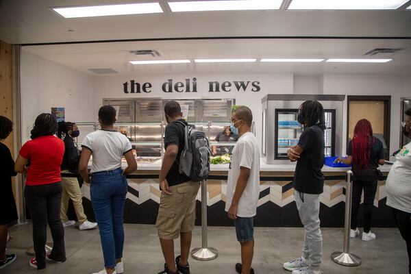 Students wait in line for lunch at Global Impact Academy in Fairburn on Monday, August 9, 2021.  (Alyssa Pointer/Atlanta Journal-Constitution)