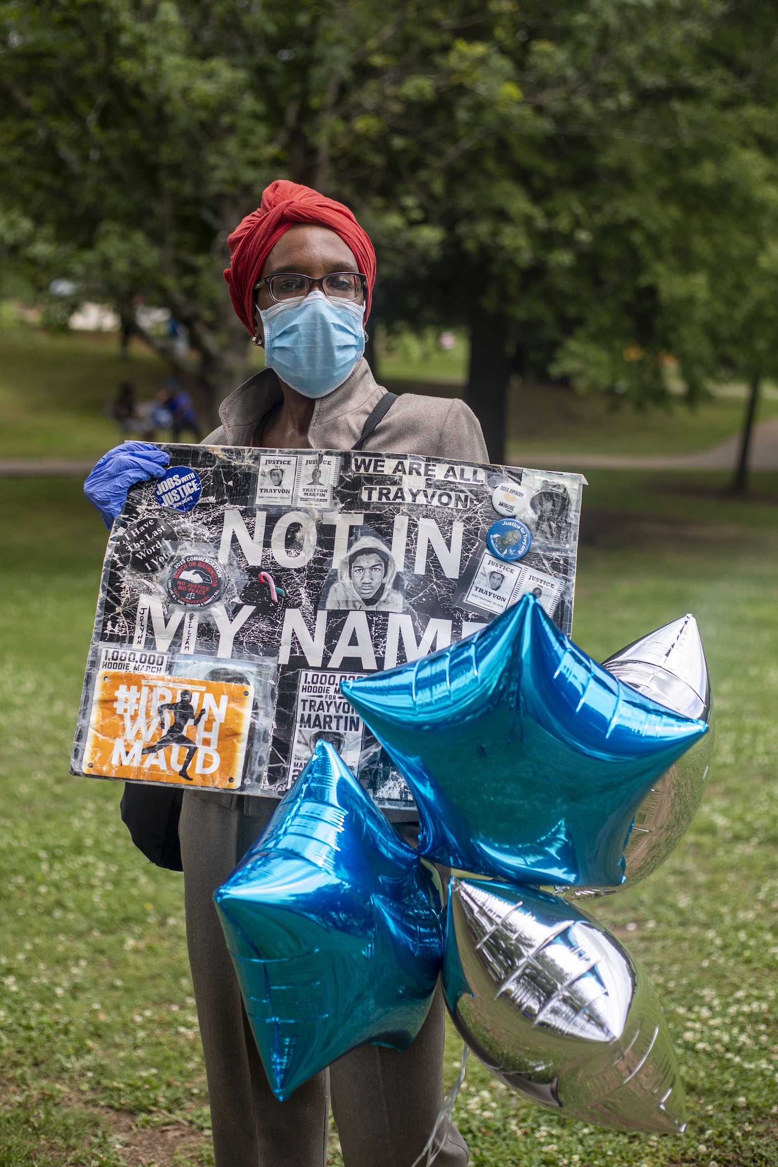 Jo-Lynn Gilliam shows off her sign, which she's used while marching over issues dating back to Troy Davis and Trayvon Martin. Gilliam participated in the "Say Her Name" peaceful protest Sunday. "I'm out here pumping my fists and pounding the pavement," said Gilliam. "This is my divine destiny." (ALYSSA POINTER / ALYSSA.POINTER@AJC.COM)