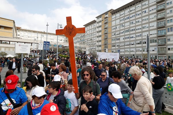 Faithfuls wait a Pope Francis appearing at a window of the Agostino Gemelli Polyclinic in Rome, Sunday, March 23, 2025, for the first time after being admitted on Feb. 14 with bronchitis that afterward worsened into bilateral pneumonia. (AP Photo/Riccardo De Luca)