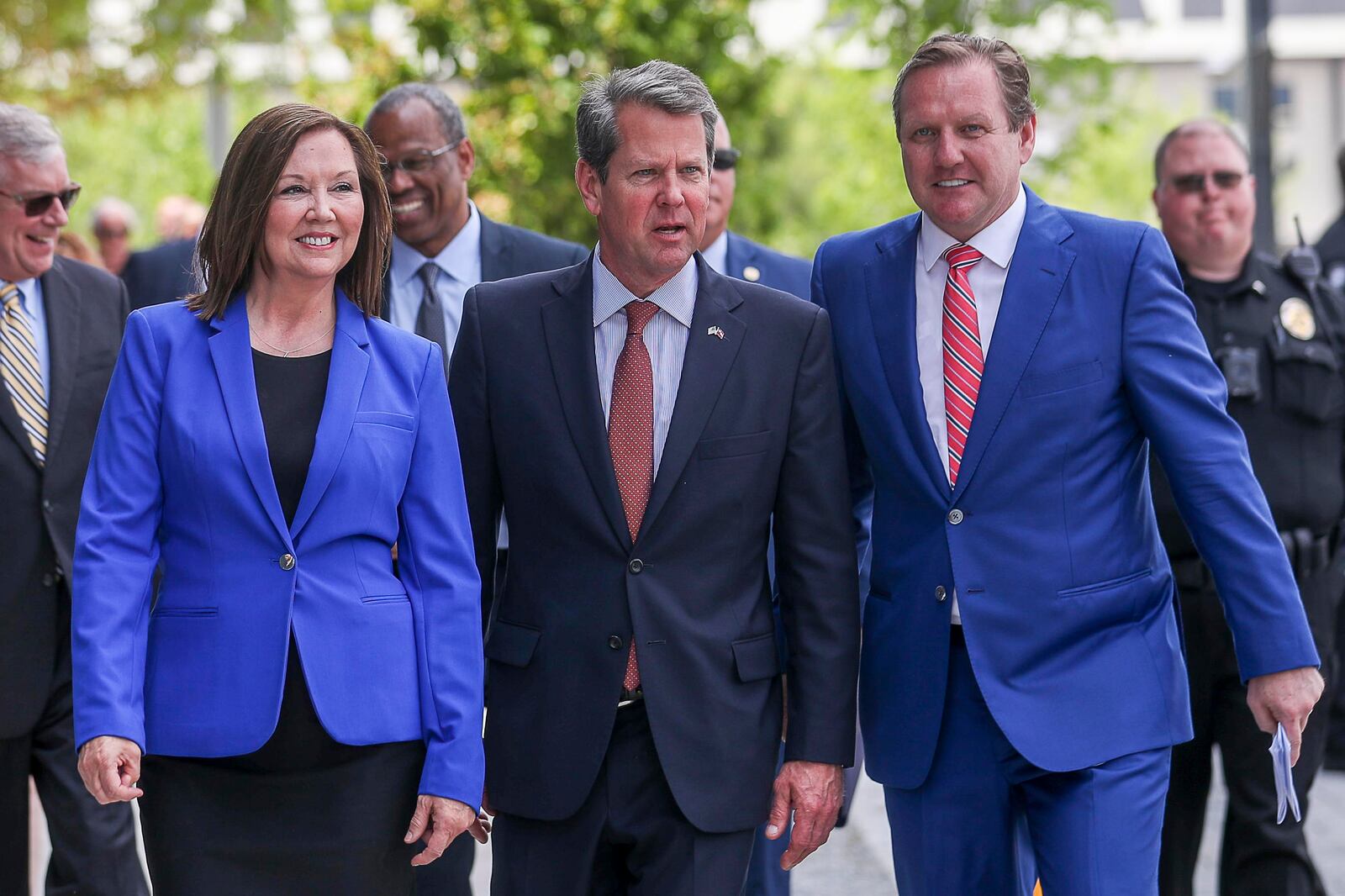 Doraville Mayor Donna Pittman (left), Georgia Governor Brian Kemp (center) and outgoing Serta Simmons Bedding CEO Michael Traub (right) prepare to speak during a grand opening celebration for Serta Simmons Bedding's new national headquarters. (ALYSSA POINTER/ALYSSA.POINTER@AJC.COM)