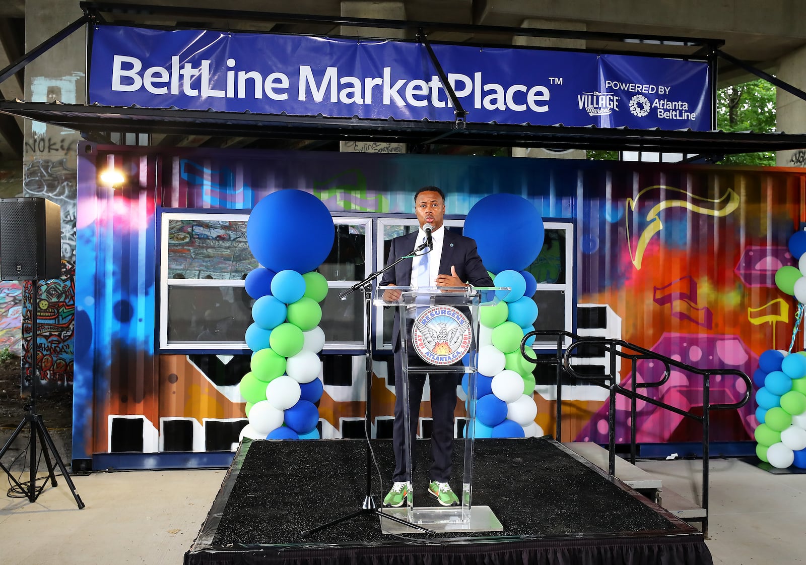 Atlanta Beltline CEO Clyde Higgs speaks during Wednesday's ribbon-cutting. The businesses will be located in refurbished shipping containers just off the Beltline path in two different areas. (Curtis Compton / Curtis Compton@ajc.com)