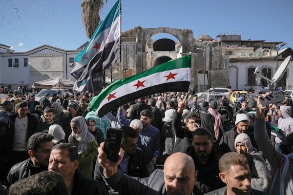 Syrians walk toward he Umayyad mosque for Friday prayers in Damascus, Syria, Friday, Dec. 12, 2024. (AP Photo/Leo Correa)