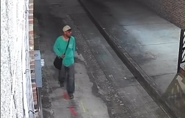 Security-camera footage of man identified as a suspect in the May 24 killing of a homeless man in downtown Macon. The suspect is pictured here looking toward the patio-like platform where Albert Kenneth Knight Jr. lay resting in the hour or so before he was beaten to death. (Bibb County Sheriff's Office.)