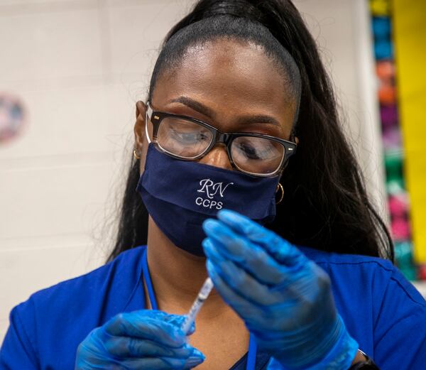 Clayton County Public Schools Nurse Supervisor Cynthia Pittman works a Clayton County Public Schools COVID-19 vaccination and testing drive at G.P. Babb Middle School in Forest Park in September. (Alyssa Pointer/Atlanta Journal Constitution)