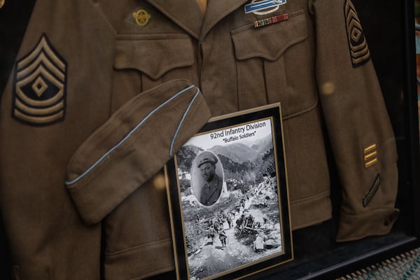 A shadowbox contains the World World II uniform of 104-year-old William Robie. Robie returned home from the war to become a professor and impactful business owner in Atlanta real estate. (Natrice Miller/AJC 2024) 