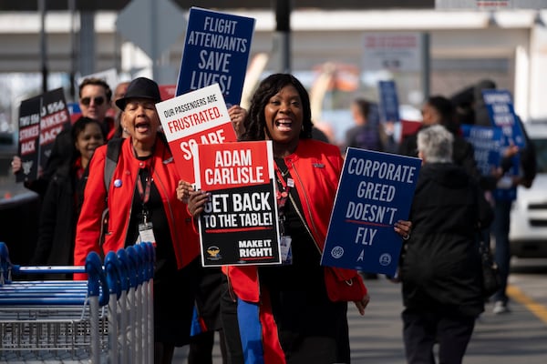 Airline employees including Veronica Espinoza, a Southwest flight attendant, picket outside of the North Terminal at Hartsfield-Jackson International Airport in Atlanta on Tuesday, Feb. 13, 2024.   (Ben Gray / Ben@BenGray.com)