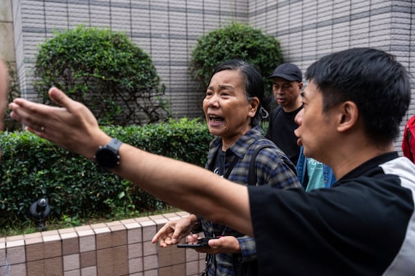 Chan Po-ying, wife of Leung Kwok-hung, one of the defendants in the national security case, leaves the West Kowloon Magistrates' Courts in Hong Kong Tuesday, Nov. 19, 2024, after the sentencing. (AP Photo/Chan Long Hei)