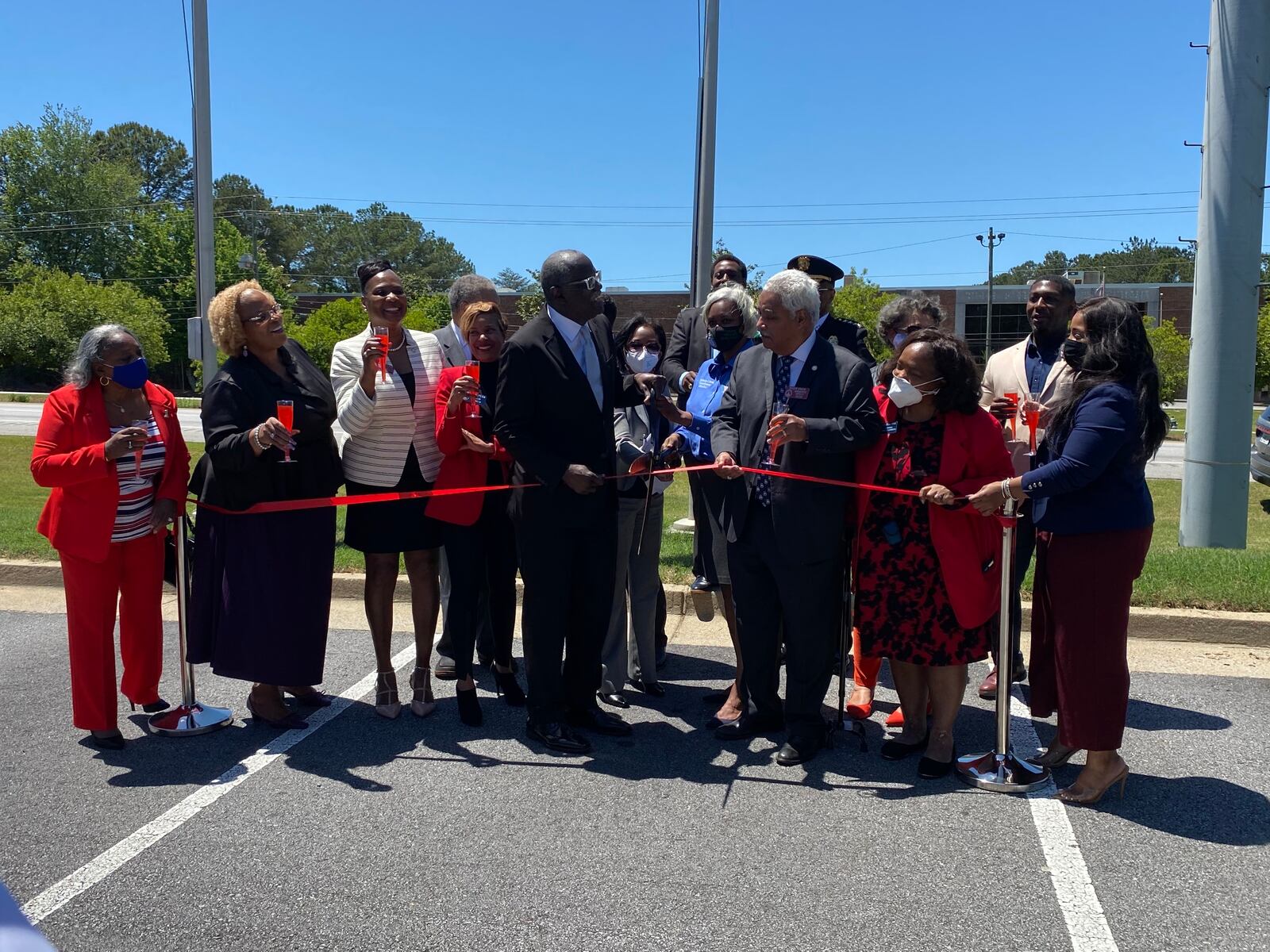 South Fulton Mayor Bill Edwards, center with ceremonial scissors, celebrates the city's annexation of most of Fulton Industrial Boulevard on Thursday, May 13, 2021. (Ben Brasch)