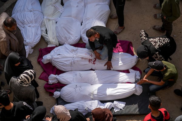 Mourners gather around the bodies of Palestinians who were killed in an Israeli army airstrikes as they are brought to Al-Ahli Hospital in Gaza City, Tuesday, March 18, 2025. (AP Photo/Abdel Kareem Hana)