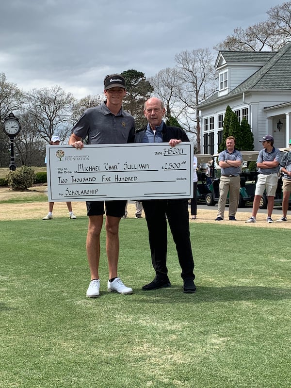 Chael Sullivan of Carrollton accepts a scholarship from World Golf Hall of Famer Larry Nelson at the Larry Nelson Invitational at the Atlanta Country Club.