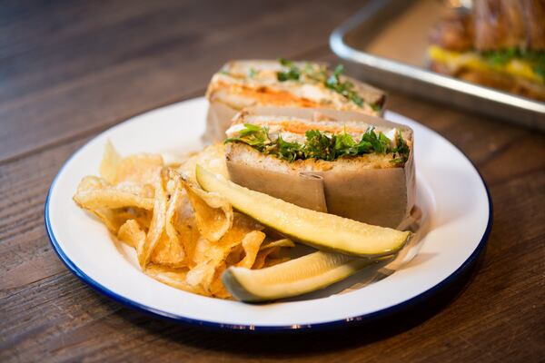 Roasted Chicken Sandwich with harissa pickled carrots and lots of herbs on sorghum bread. Photo credit -Mia Yakel.